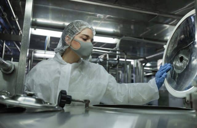 Young Female Worker Controlling Production at Clean Food Factory